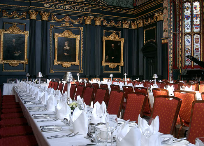 Tables set for dinner in the Old Hall, with historic portraits and opulent decoration, it is a truly splendid setting for private dining.