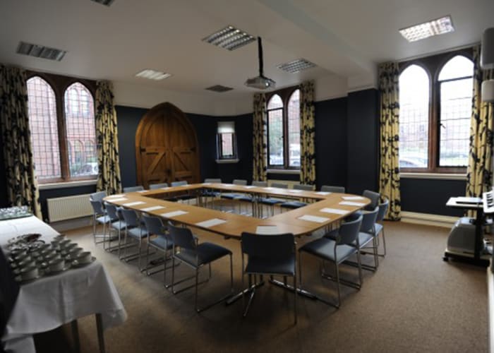 A beautiful meeting room, the old arched oak chapel door and arched windows add character.