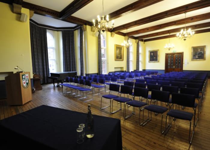 A light, spacious meeting room at Girton College with a stage located at one end with a data projector, screen and full WiFi access.