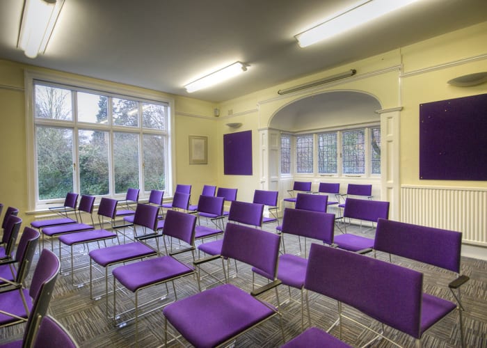 A meeting room complete with chairs set in rows, ideal for presentations and workshops.