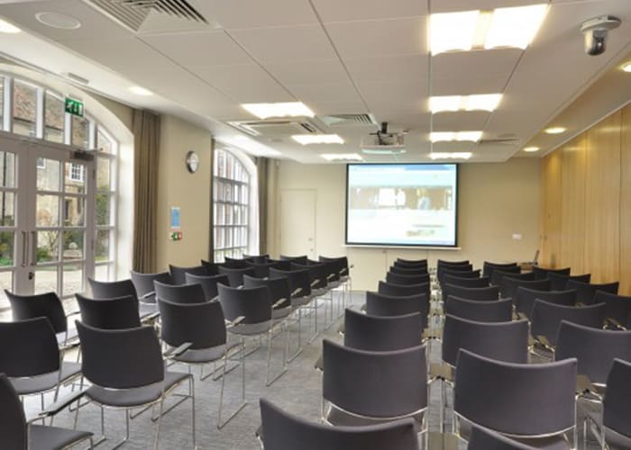 White ceiling with large spotlights, floor to ceiling windows for lots of daylight and a backdrop of the Courtyard. Offers flexible room layouts, breakout and catering area with the latest AV.