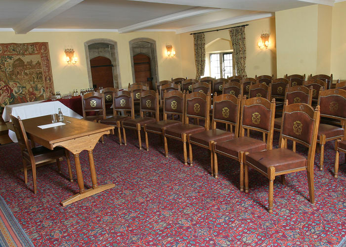 An attractive, bright room with pale yellow walls and rows of traditional College chairs with a top table. This flexible space lends itself to meetings and seminars for smaller groups.