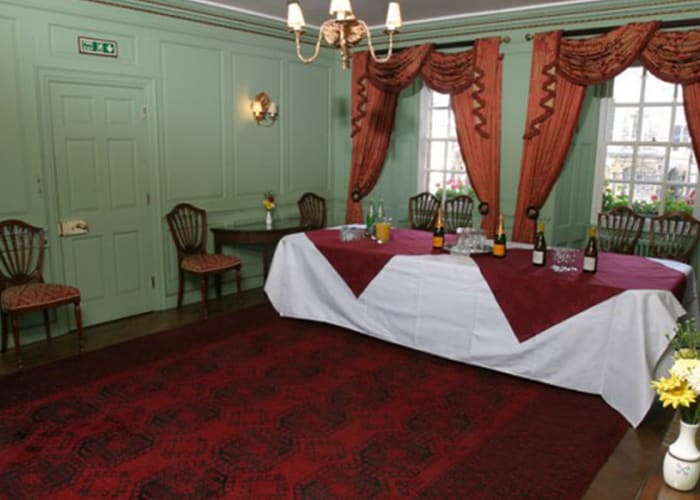 This pale green panelled Georgian room, beautifully furnished with antiques and lots of natural daylight is an ideal setting for small meetings, presentations, seminars and drinks receptions.