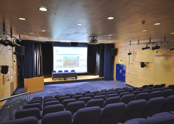 Providing tiered seating for up 119 and can accommodate up to 130 people with additional chairs at the front of the room
