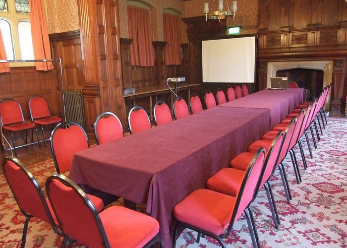 The Knox Shaw Room has wooden panelling, open fires and red hues, creating a warming atmosphere for any event.