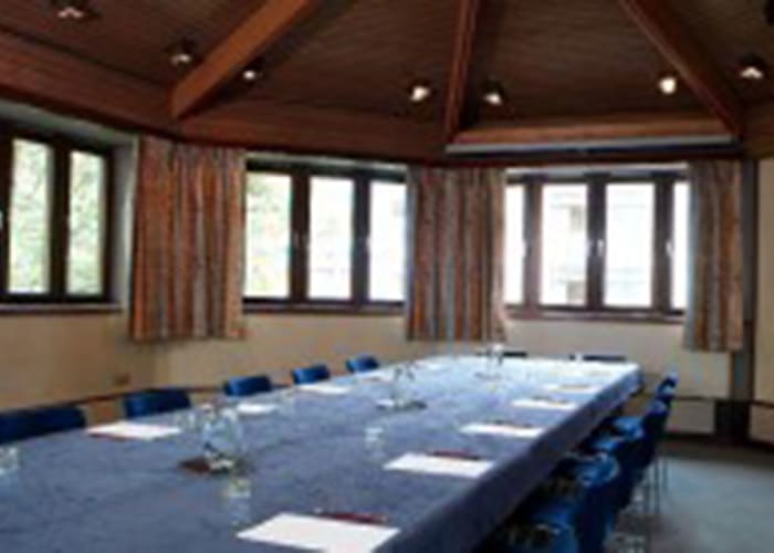 Spacious Seminar Room with windows around the room, it is a light space for day meetings.