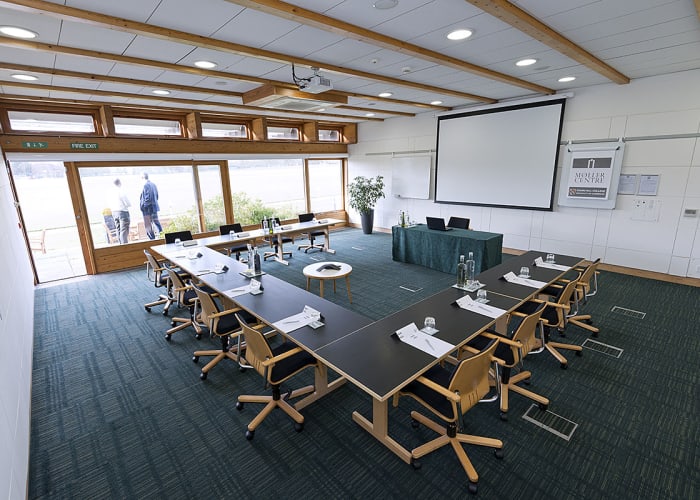 Situated within the Study Centre, this room features views across Churchill College's grounds and has sliding external doors that open out onto a patio area.