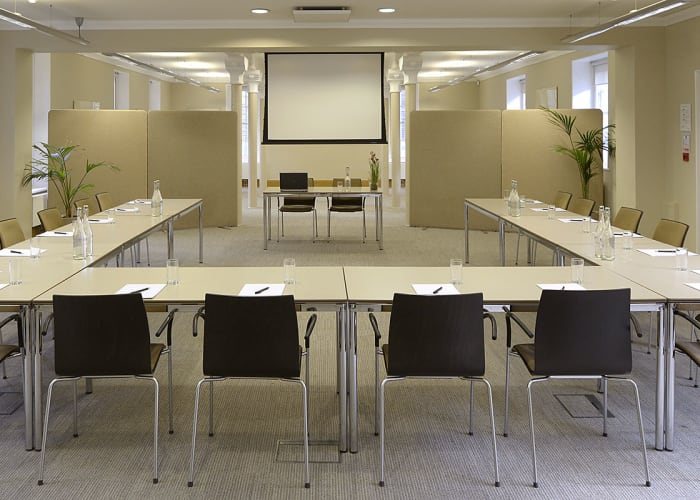 A versatile and spacious conference suite with climate control, natural light, built-in high specification audio-visual equipment, induction loops, wheelchair access and WiFi access. This is our largest room and is often combined with the use of the adjacent Newton Room for lunches and networking reception space.