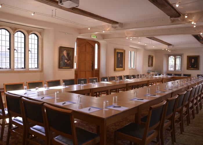 The Graham Storey Room set boardroom style for a business meeting, with complimentary notepads and pens for delegates.