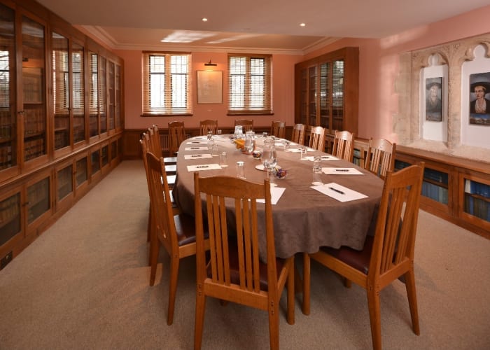 The Stephen Hawking Room is an ideal space for business meetings, an attractive room with historic features and volumes from the Library line the walls.