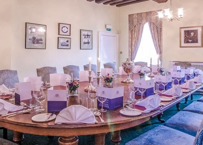 A traditional private dining room set for an event with views of St John's College Chapel.