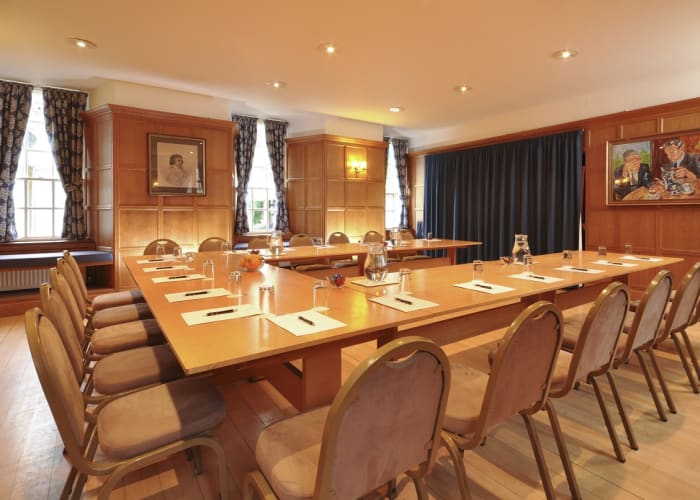Bridgetower Room at Trinity Hall panelled walls. U shaped table setting and complimentary notepads and pen for delegates