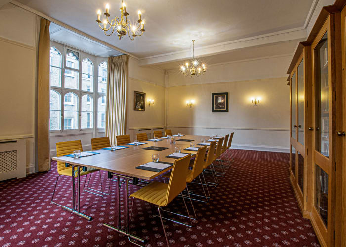 A traditional and bright meeting room with a boardroom table for 10 delegates.