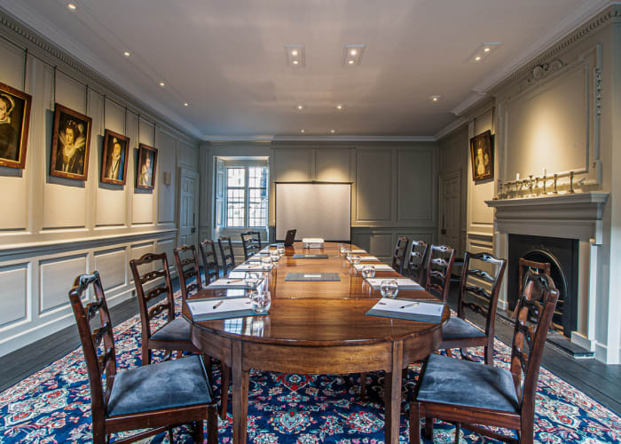 A beautiful and traditional meeting room with a solid oak table set for 12 delegates.