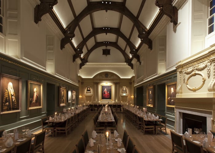 The dining hall at Trinity College by candle light in the evening, a exceptional venue for private dining.
