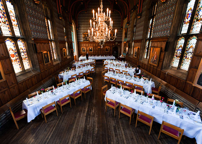 An aerial view of the dining hall, with an opulent chandelier and stained glass windows, it provides an expectional experience for private dining.