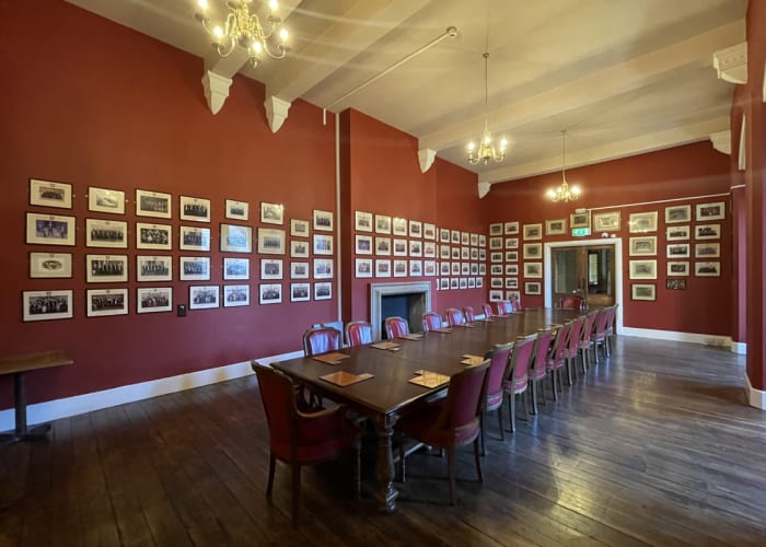 The Dining Room at the Cambridge Union Society, the walls are lined with images of previous committees.