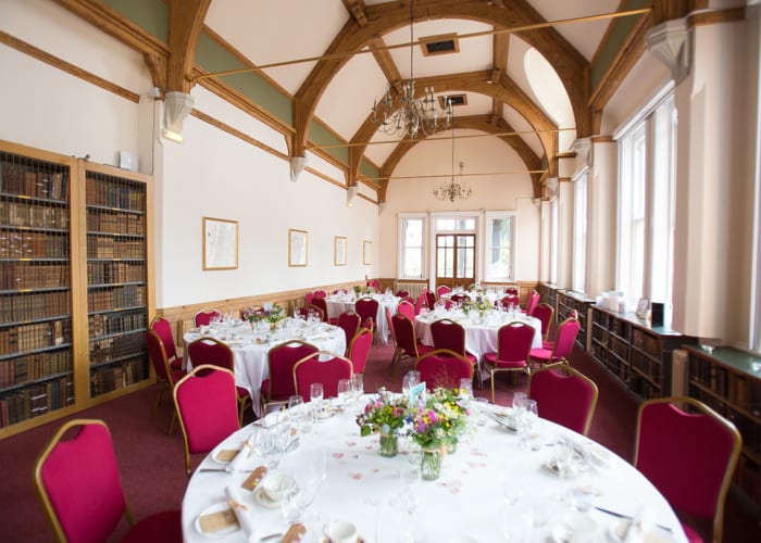 A beautiful, traditional room with large windows filling the room with natural daylight, set for a private dinner.