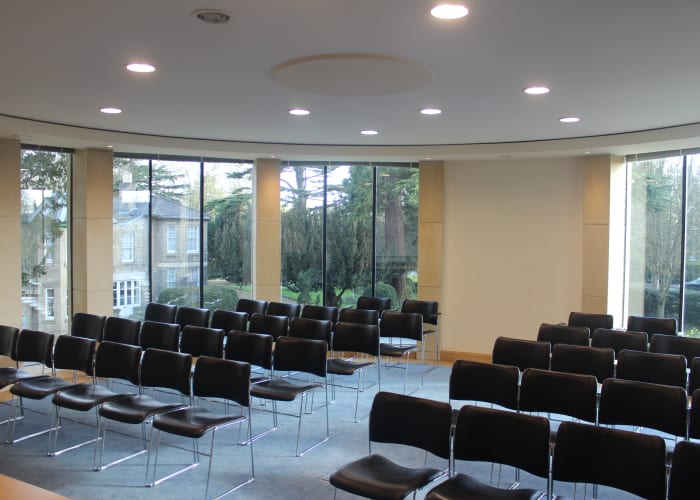 A modern conference room with built-in AV equipment able to seat up to 50 delegates.