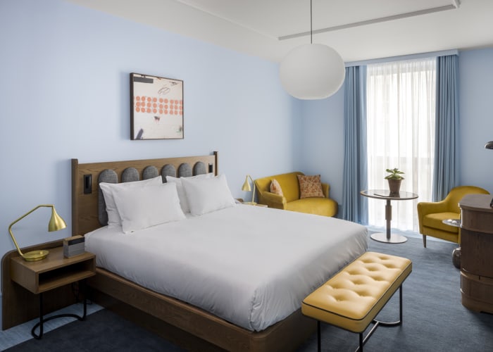 Offering a view over the courtyard this King Deluxe room at the Hyatt Centric Cambridge is decorated in mustard and blue tones and it offers a super king bed.