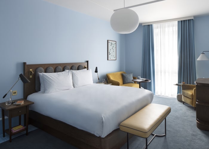 A Hyatt King bedroom located at Cambridge. A super king bed in a decorated in tones of warming mustard and calming blue.
