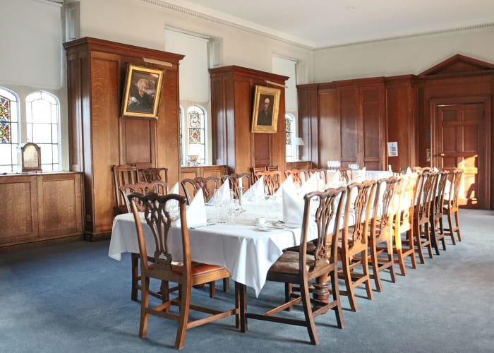 Wooden panelling and stained glass windows add charm to this traditional meeting room with a boardroom table for 16 delegates.