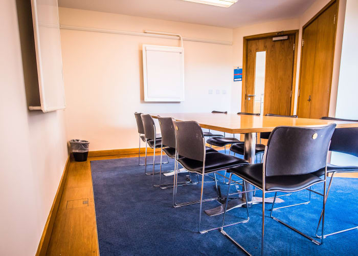 A syndicate room set 8 people boardroom style, ideal for interviews and small meetings.