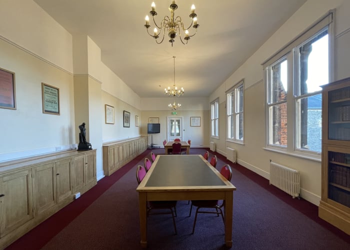 The Snooker Room at Cambridge Union Society, filled with natural daylight and set boardroom great for day meetings.