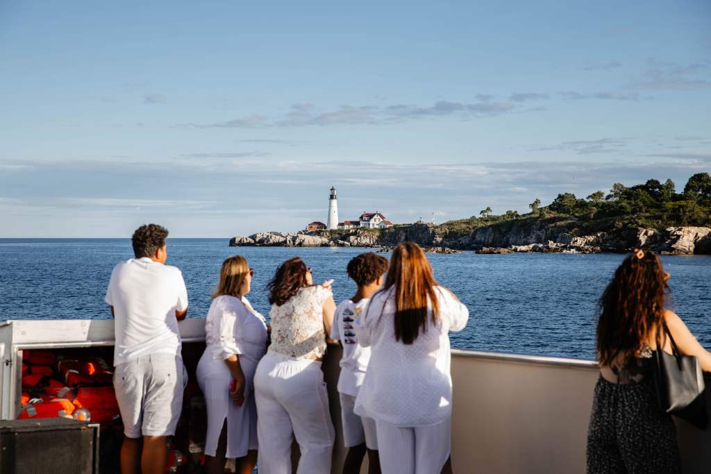 Group on Boat by Portland Head Light. Photo Credit: Cailyn Burke/@cailyns_camera