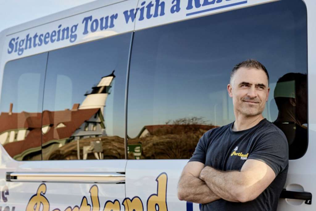Owner in front of The Real Portland Tour Bus. Photo Credit: Michael Wilson