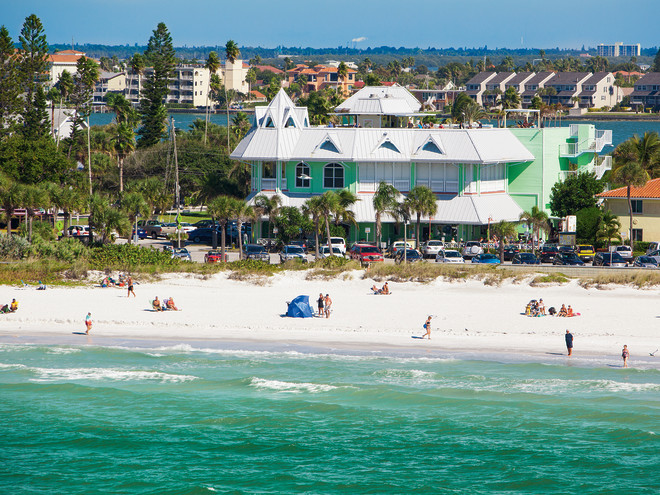 Photos of the outside of Hurricane Seafood Restaurant with the beach forefront.
