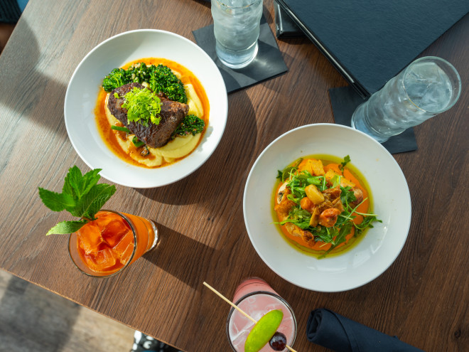 Plated dishes and cocktails from Teak Restaurant