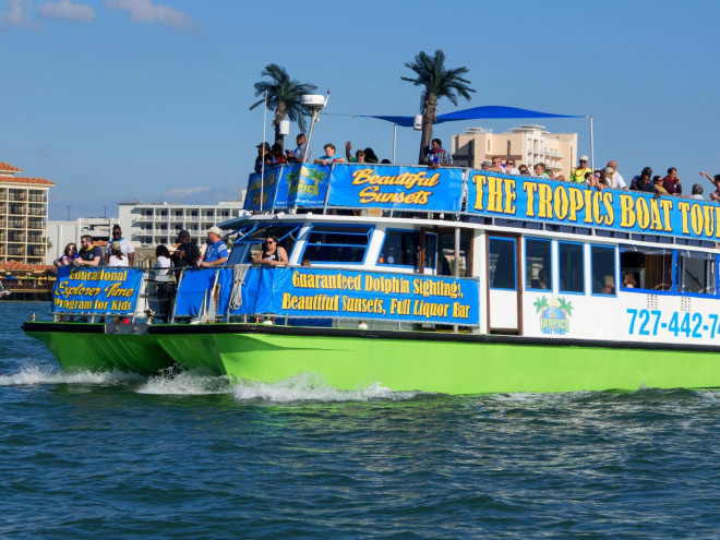 a colorful sightseeing boat call The Tropics Boat Tours in Clearwater Beach
