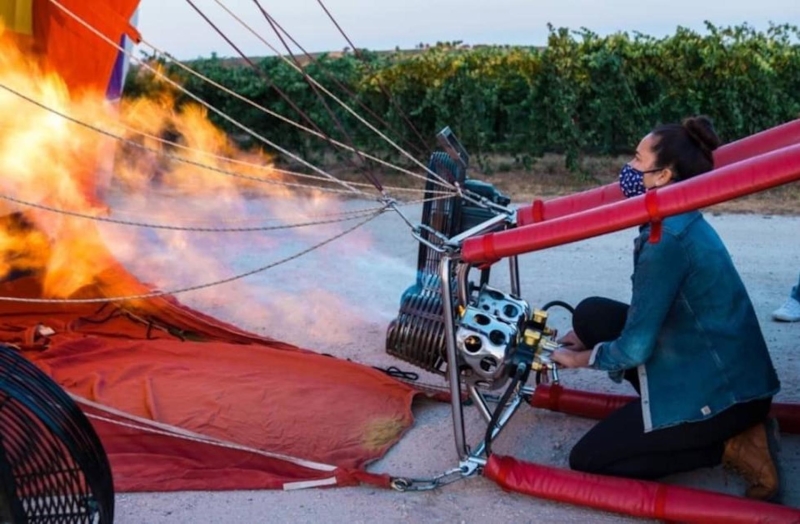 Lady filling up a hot air balloon