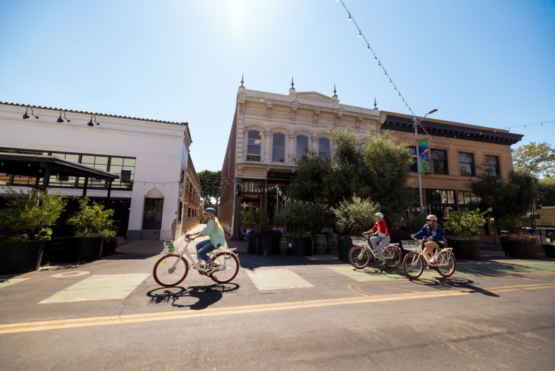 Bikers in bike lane peddling bast building skyline in downtown San Luis Obispo, CA