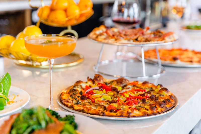 Table with Citrus, pizza and beverages