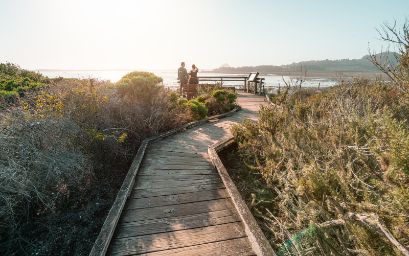Couple walking on the Baywood Boardwalk in Los Osos & Baywood Park, San Luis Obispo County, California