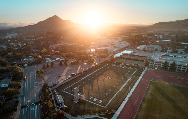 Ariel view of Cal Poly football field with mountains in the back
