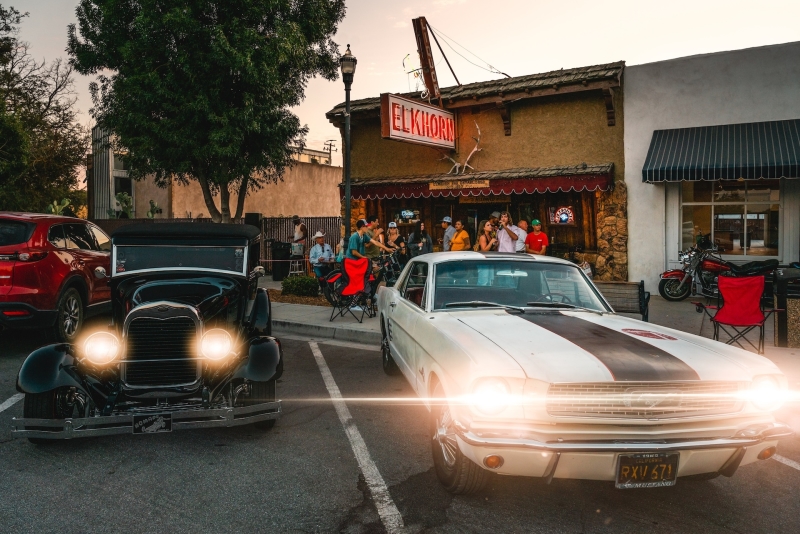 Old fashion cars parked outside the Elkhorn Bar. People gathered at the entrance.