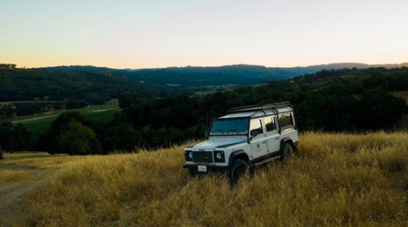 Jeep on open ranch at sunset