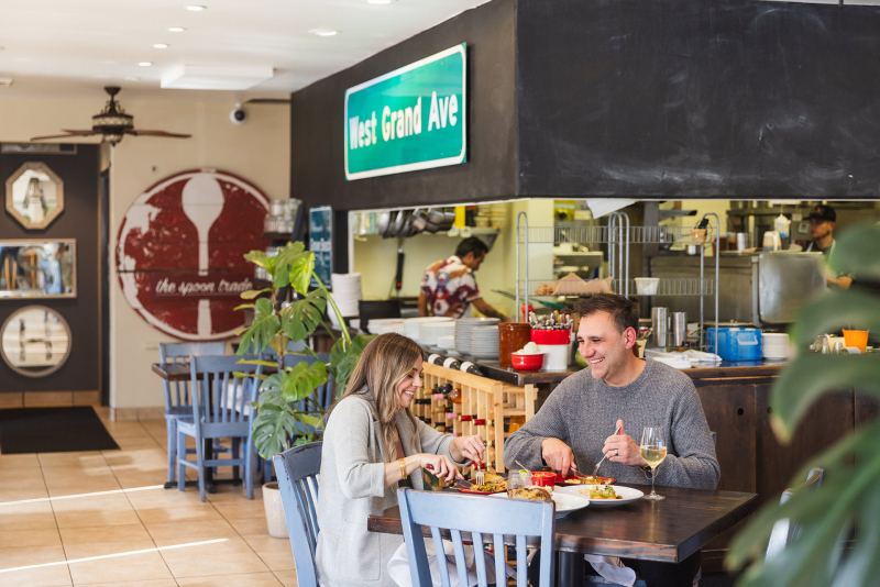 Couple enjoying food and drink at The Spoon Trade Dining Room