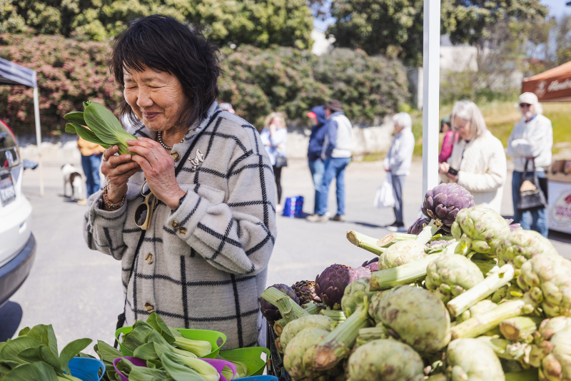 Shanny Covey of Robin's Restaurant in Cambria selects vegetables at the farmers market