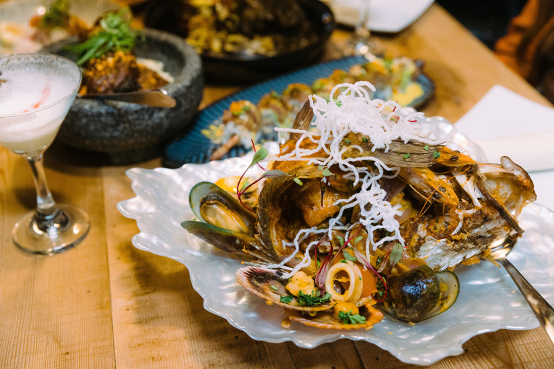 Plates of seafood and cocktails at Mitsura restaurant