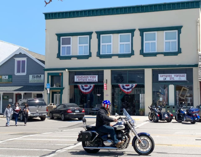 a motocycle riding by Remember When Antiques in Cayucos