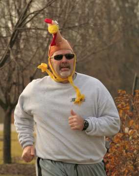 Guy running in Run with the Turkeys 5K/10K with Turkey hat