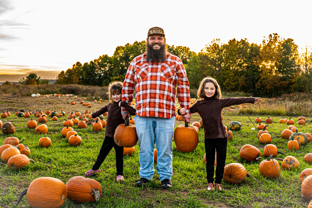 Father Daughters Picking a Pumpkin
