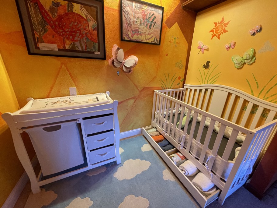 Nursery with full crib, changing table, and baby monitors