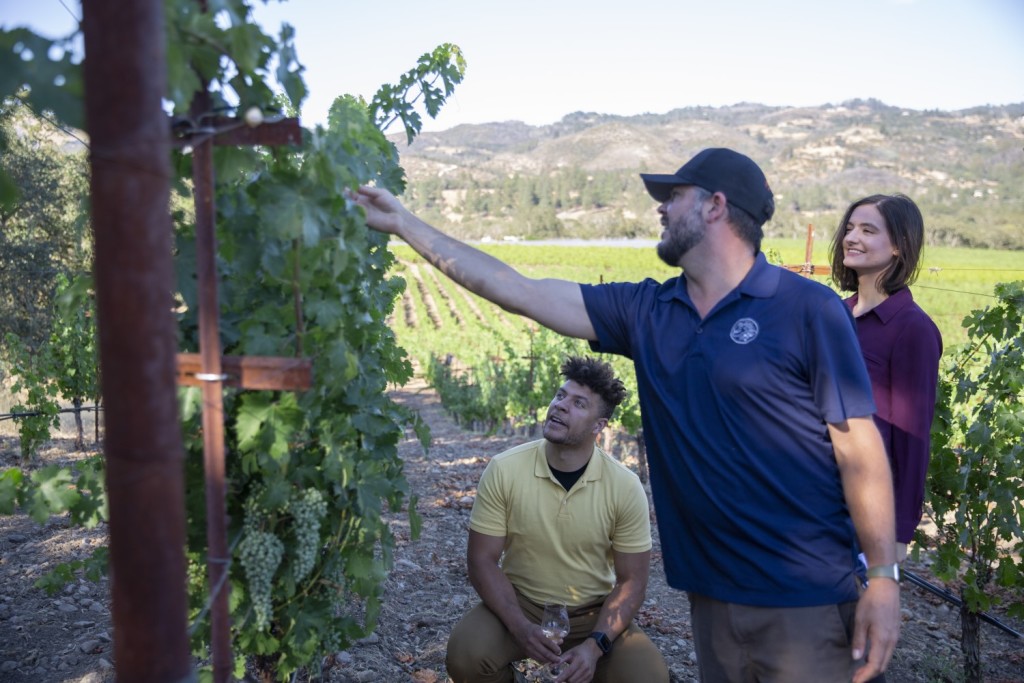 Alex in vineyard with guest