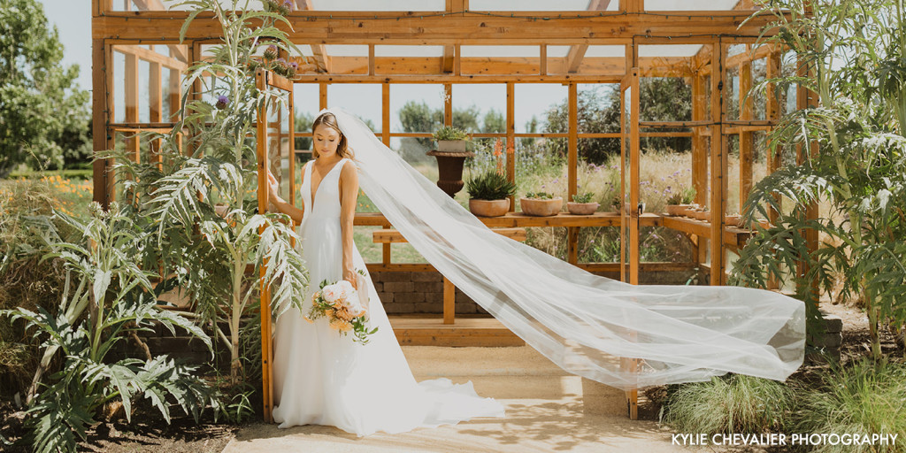 Bride in front of Greenhouse
