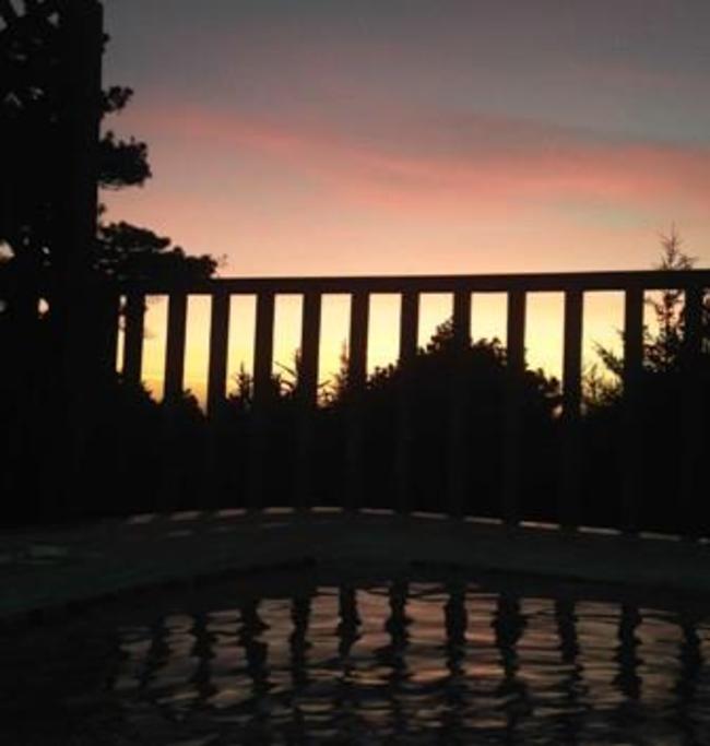 Hot tub at our Backpack vacation home during sunset